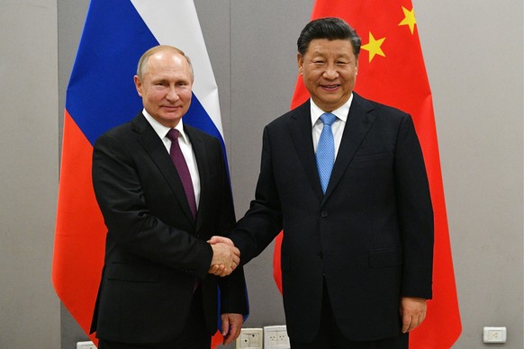 BRASILIA, BRAZIL NOVEMBER 13, 2019: Russia s President Vladimir Putin L shakes hands with China s President Xi Jinping during a meeting on the sidelines of the 11th BRICS Summit. Ramil Sitdikov/POOL/T ...