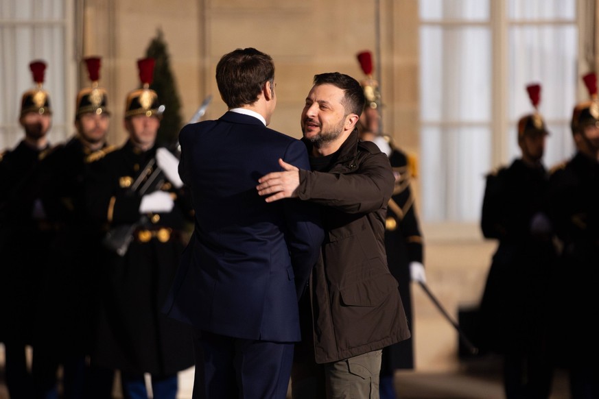 Paris, France, February 16, 2024 - France s President Emmanuel Macron welcomes Ukraine s President Volodymyr Zelensky upon his arrival at the presidential Elysee palace to sign a bilateral security ag ...