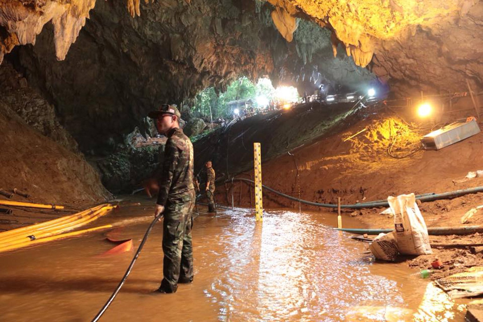 Members of the Royal Thai Navy along with volunteers from England, the United States, Australia, and China, are pictured as they prepare to rescue 12 schoolboys, members of a local soccer team, and th ...