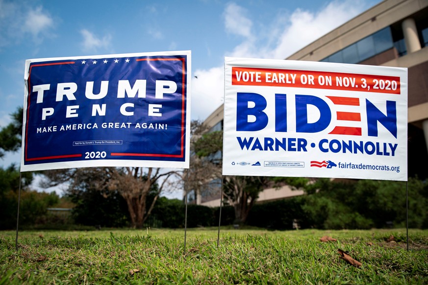 FILE PHOTO: Yard signs supporting U.S. President Donald Trump and Democratic U.S. presidential nominee and former Vice President Joe Biden are seen outside of an early voting site at the Fairfax Count ...