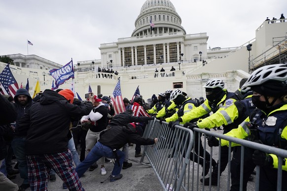 Trump supporters try to break through a police barrier, Wednesday, Jan. 6, 2021, at the Capitol in Washington. As Congress prepares to affirm President-elect Joe Biden's victory, thousands of people h ...