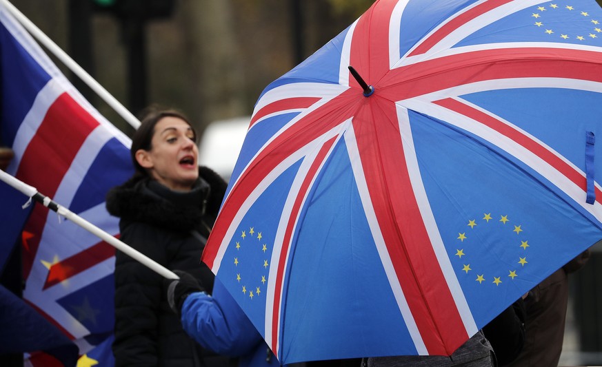 Protestors shout against Brexit opposite the House of Parliament in London, Tuesday, Nov. 27, 2018. Prime Minister Theresa May made a blunt appeal to skeptical lawmakers on Monday to back her divorce  ...