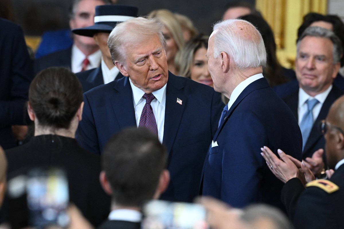President Joe Biden talks to President-elect Donald Trump as he arrives during the inauguration ceremony before Trump is sworn in as the 47th US President in the US Capitol Rotunda in Washington, DC,  ...