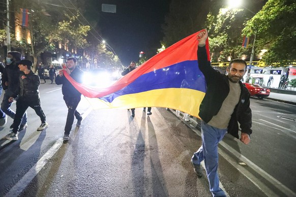 YEREVAN, ARMENIA - NOVEMBER 10, 2020: Demonstrators protesting against the end of war in Nagorno Karabakh march in central Yerevan. On 10 November 2020, Armenia s prime minister Pashinyan, Russia s pr ...
