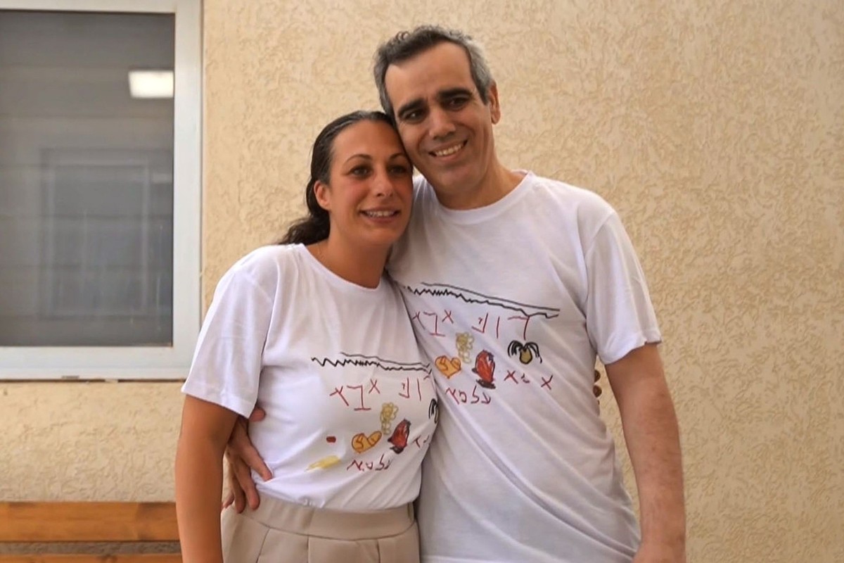 In this photo provided by the Israeli Defense Forces, Omri Miran hugs his wife Lishay Miran-Lavi after released from Hamas, in Israel on Monday, Oct. 13, 2025. (IDF via AP)