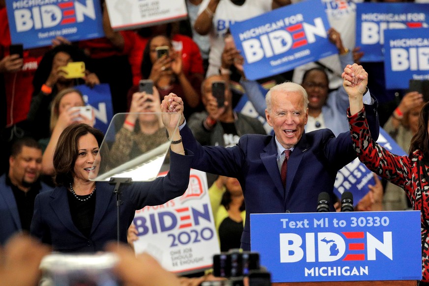 FILE PHOTO: Democratic U.S. presidential candidate and former Vice President Joe Biden and U.S. Senator Kamala Harris hold hands during a campaign stop in Detroit, Michigan, U.S., March 9, 2020. REUTE ...