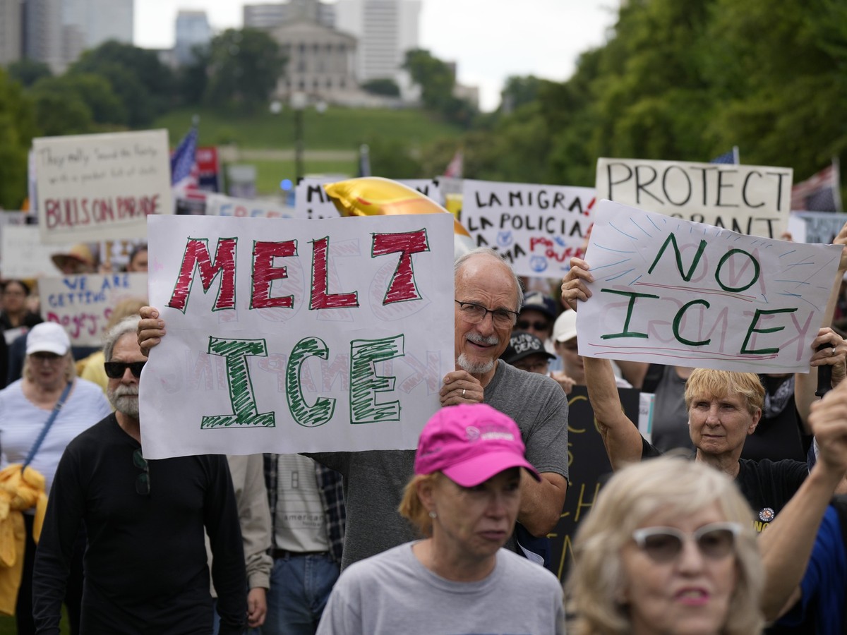 Mike Hodge, center, holds a Melt Ice sign during a "No Kings" protest Saturday, June 14, 2025, in Nashville, Tenn. (AP Photo/George Walker IV)