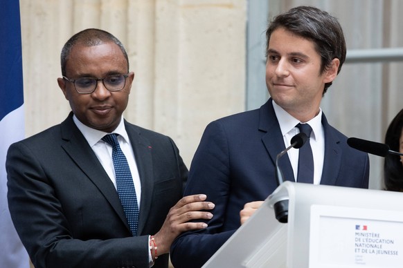 Paris, France, July 20, 2023 - Newly appointed France s Education Minister Gabriel Attal R is next to former French Education and Youth Minister Pap Ndiaye L during a handover ceremony at the Ministry ...