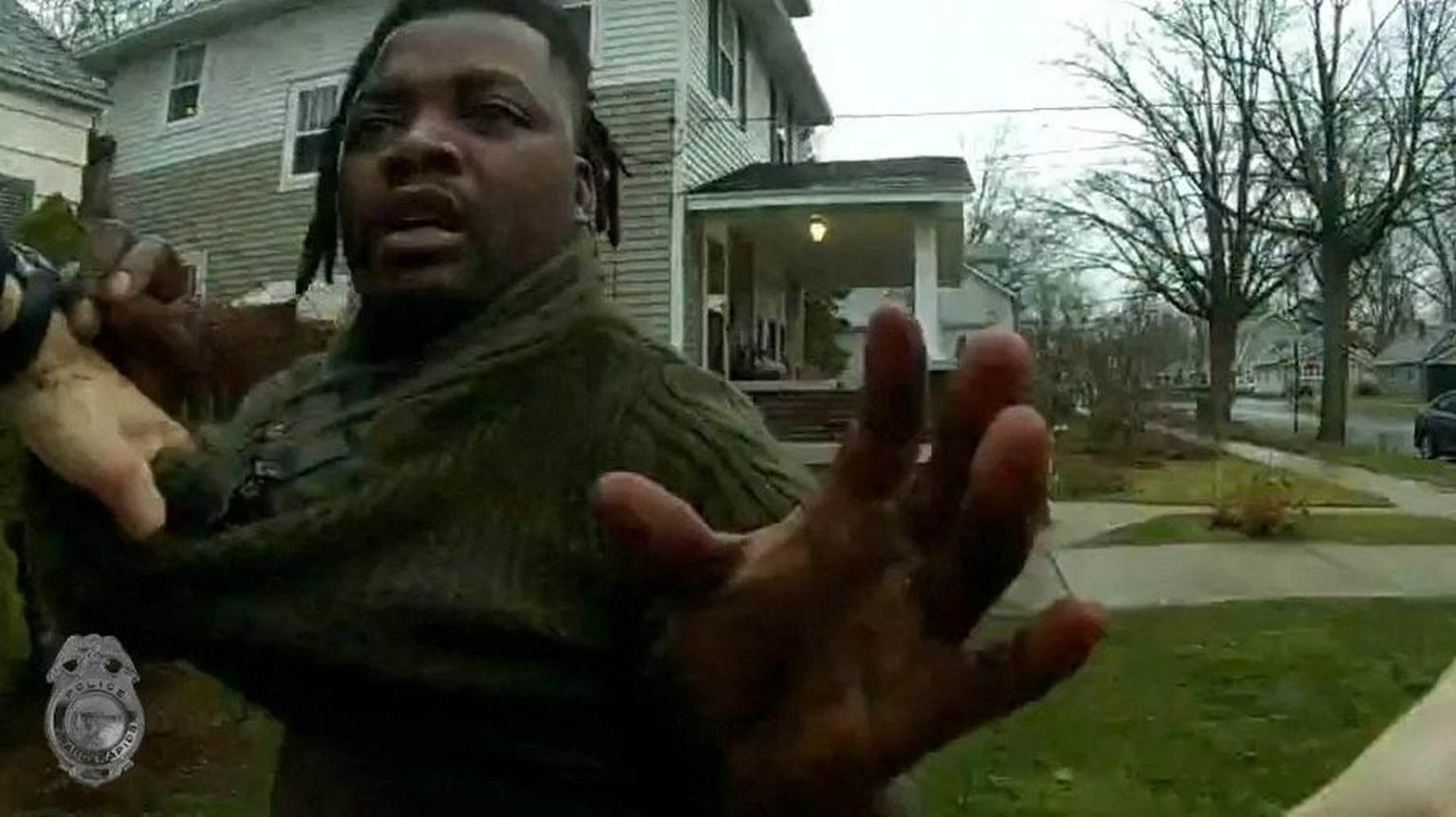 A Grand Rapids Police officer grasps the shirt of Patrick Lyoya during a traffic stop, shortly before Lyoya was shot dead by the officer during a scuffle on a suburban front lawn in Grand Rapids, Mich ...