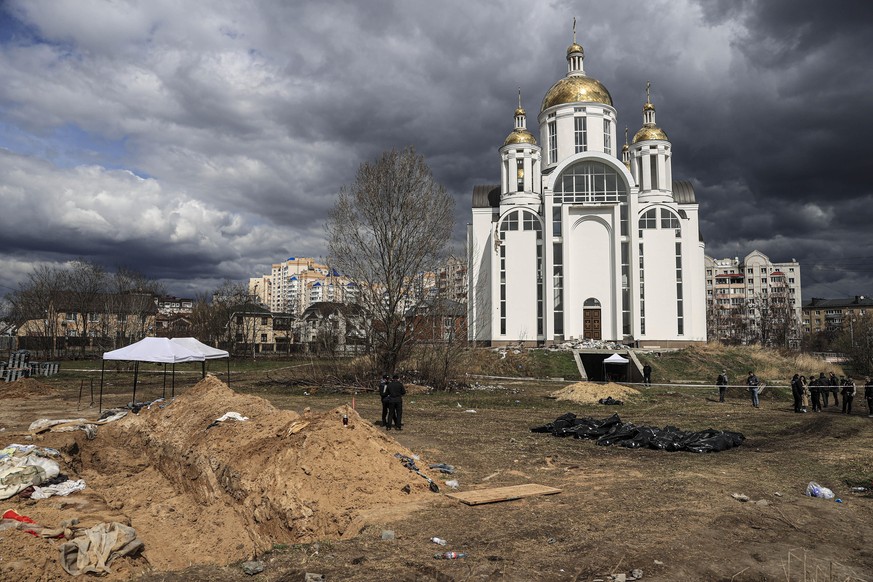 BUCHA, UKRAINE - APRIL 11: (EDITORS NOTE: Image depicts death) Officials exhume the bodies of civilians who died during the Russian attacks, from mass graves in Bucha, Ukraine on April 11, 2022. Accor ...