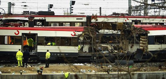 MADRID, SPAIN - MARCH 12: One of the bomb damaged trains is towed past another at Atocha train station on March 12, 2004 in Madrid, Spain. According to judicial sources 198 people were killed in the s ...