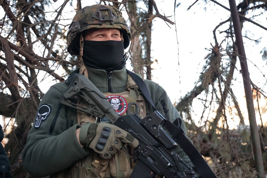 UKRAINE, DONETSK REGION - APRIL 10, 2023: A Wagner Group soldier guards a street in the city of Artyomovsk Bakhmut. Artyomovsk is located in the Kiev-controlled area of the Donetsk People s Republic.  ...