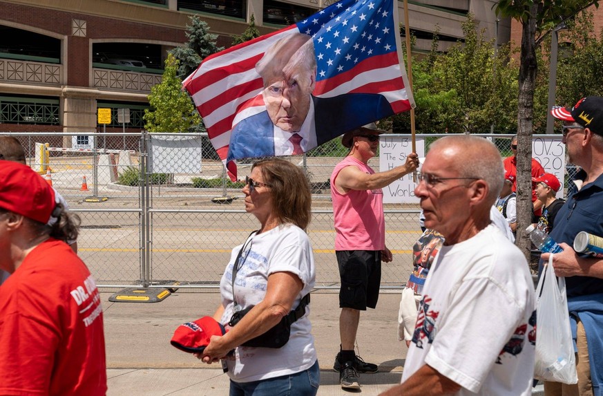 Syndication: Detroit Free Press Karl Holland holds a flag with former President Donald Trump s image during a rally at the Van Andel Arena in Grand Rapids on Saturday, July 20, 2024. Detroit , EDITORI ...