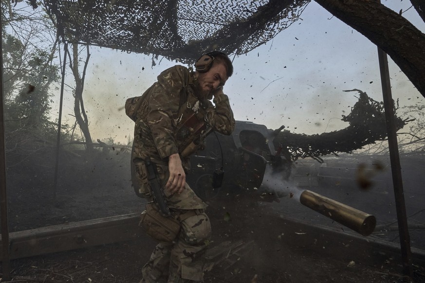 A Ukrainian serviceman of the 10th Assault Brigade Edelweiss fires a D-30 cannon towards Russian positions at the front line, near Bakhmut, Donetsk region, Ukraine, Wednesday, July 5, 2023. (AP Photo/ ...