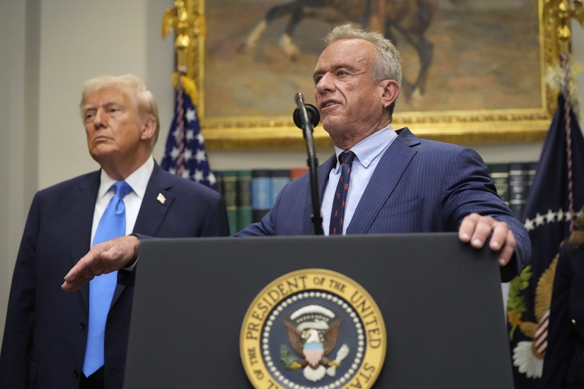 President Donald Trump listens as Health and Human Services Secretary Robert F. Kennedy Jr., speaks in the Roosevelt Room of the White House, Monday, Sept. 22, 2025, in Washington. (AP Photo/Mark Schi ...