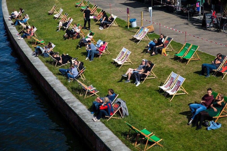 BERLIN, GERMANY - MAY 26: Visitors sit in a bar on chairs that are set apart to provide social distance during the coronavirus crisis on May 26, 2020 in Berlin, Germany. (Photo by Maja Hitij/Getty Ima ...