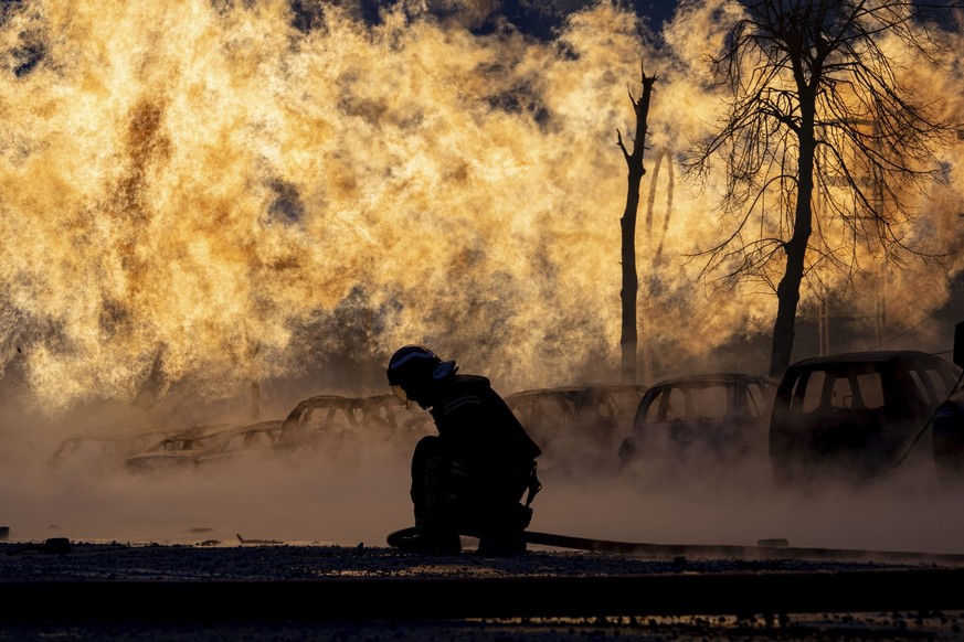 A firefighter works to extinguish a fire of a gas pipe line damaged by a Russian rocket attack, in Kyiv, Ukraine, Tuesday, Jan. 2, 2024. (AP Photo/Evgeniy Maloletka)