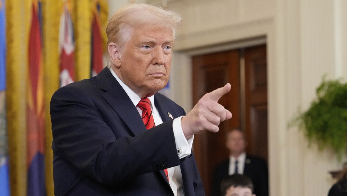 President Donald Trump gestures after signing executive order in the East Room of the White House in Washington, Thursday, March 20, 2025. (AP Photo/Ben Curtis)