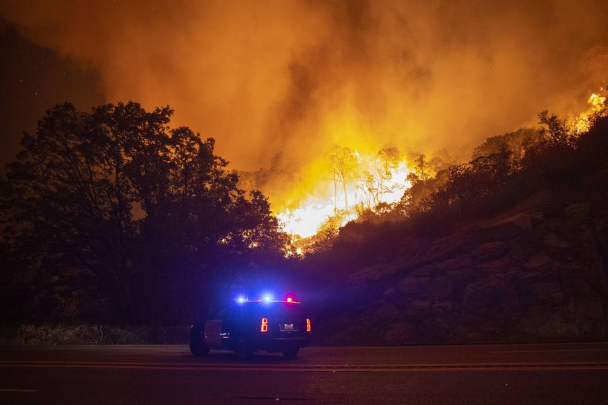 California Highway Patrol turns around as he is blocked bu impending flames along Hwy 168 as the Creek Fire rapidly expands on September 8, 2020 near Shaver Lake, California. California Gov. Gavin New ...