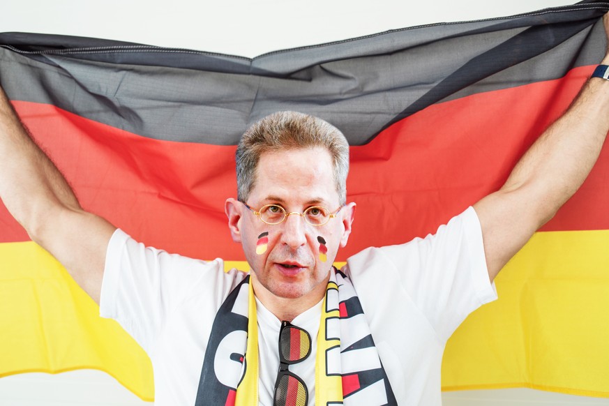 Soccer fan cheering at the game. Holding national team flag, with color paint on face. Studio shot