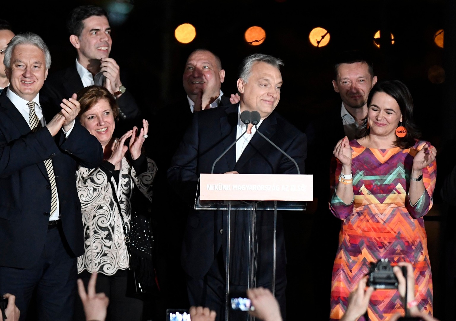 Hungarian Prime Minister and Chairman of Fidesz Party Viktor Orban, center, and Deputy Prime Minister and Chairman of the Christian Democratic Party Zsolt Semjen, left, celebrate the win of Fidesz and ...
