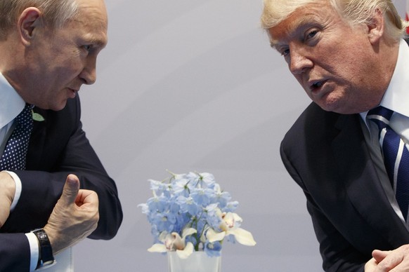 FILE – Then-U.S. President Donald Trump, right, meets with Russian President Vladimir Putin at the G20 Summit in Hamburg, Germany, Friday, July 7, 2017. While in power, Trump derided the leaders of so ...