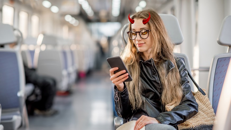 Lifestyle portrait of a young businesswoman sitting with smart phone at the modern train