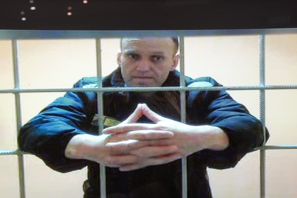 FILE - In this image provided by the Russian Federal Penitentiary Service, opposition leader Alexei Navalny appears in a video link provided by the Russian Federal Penitentiary Service in a courtroom  ...