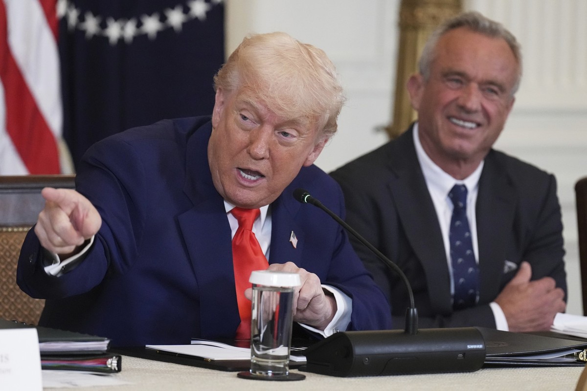 President Donald Trump, left, speaks as Health and Human Services Secretary Robert F. Kennedy Jr. listens during a Make America Healthy Again (MAHA) Commission Event in the East Room of the White Hous ...