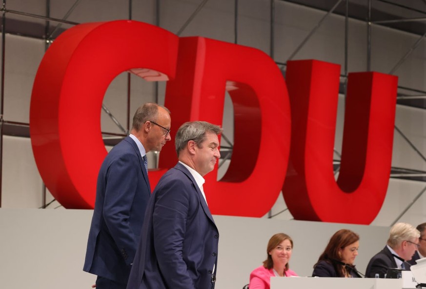 HANOVER, GERMANY - SEPTEMBER 10: Markus Soeder (C), leader of the Christian Social Union (CSU), the Bavarian sister party of the German Christian Democrats (CDU), stands with CDU leader Friedrich Merz ...