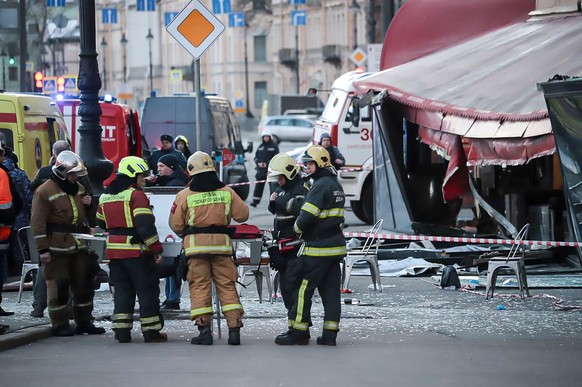 Russian Emergency Situations Ministry stand at the side of an explosion at a cafe in St. Petersburg, Russia, Sunday, April 2, 2023. An explosion tore through a cafe in the Russian city of St. Petersbu ...