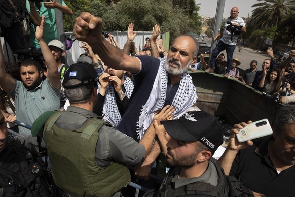 Palestinians scuffle with Israeli police officers during a visit by Israeli right wing Knesset members to the Sheikh Jarrah neighborhood of east Jerusalem, Monday, May 10,2021. (AP Photo/Sebastian Sch ...