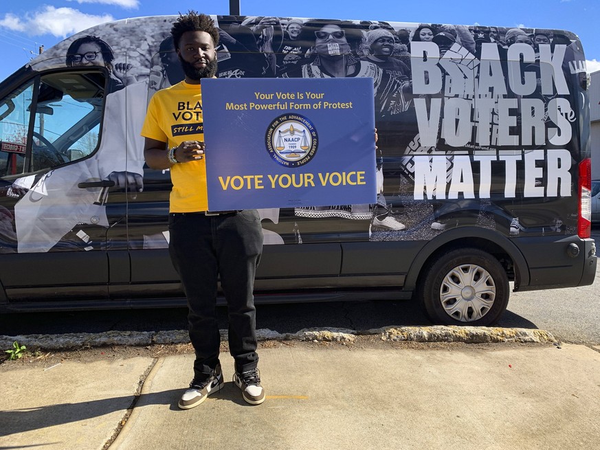 November 27, 2022, Atlanta, Georgia, USA: With the Black Voters Matter van behind him, this man reminds people passing by of the importance of the vote. Atlanta USA - ZUMAd155 20221127_znp_d155_031 Co ...