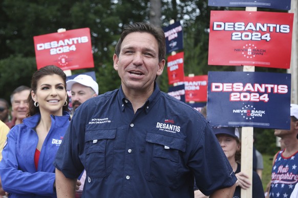 FILE - Republican presidential candidate and Florida Gov. Ron DeSantis and his wife Casey, walk in the July 4th parade, July 4, 2023, in Merrimack, N.H. DeSantis is defending an anti-LGBTQ video his c ...