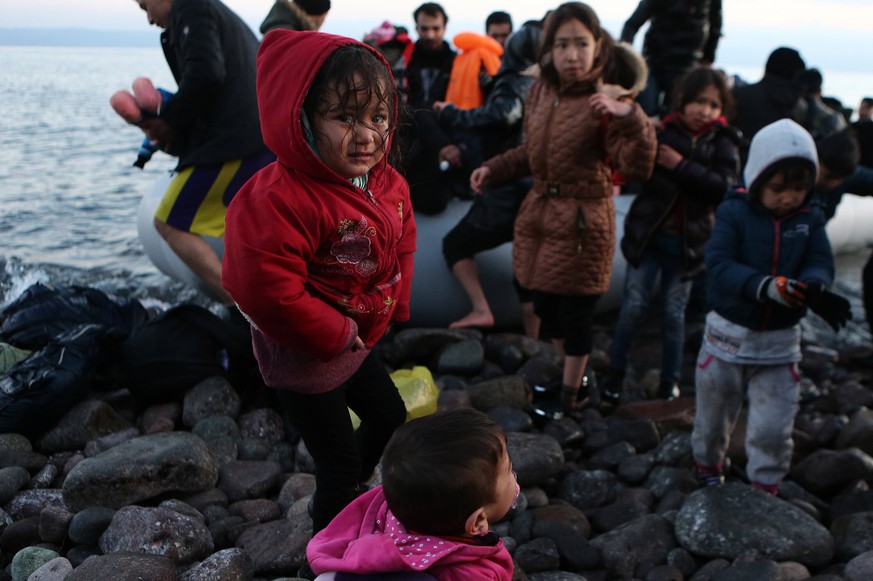 200302 -- LESVOS, March 2, 2020 -- Photo taken on March 2, 2020 shows children coming off a boat after arrival at Skala Sikaminias, in the island of Lesvos, Greece. At least five boats, carrying aroun ...