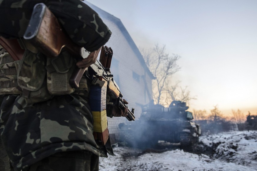 epa04544463 A picture made available 01 January 2015 shows a Ukrainian soldier looking at a tank near Peski village, Donetsk area, Ukraine, 31 December 2014, few hours before the 2015 celebrations. Uk ...