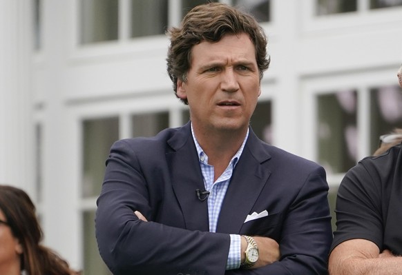 FILE - Tucker Carlson attends the final round of the Bedminster Invitational LIV Golf tournament in Bedminster, N.J., July 31, 2022. A racist text message from Tucker Carlson is what helped drive the  ...
