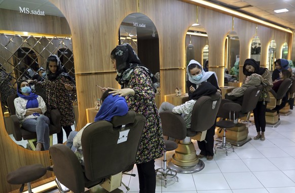 FILE- Beauticians put makeup on customers at Ms. Sadat&#039;s Beauty Salon in Kabul, Afghanistan, Sunday, April 25, 2021. A spokesman at Afghanistan&#039;s Vice and Virtue Ministry said Tuesday, July  ...