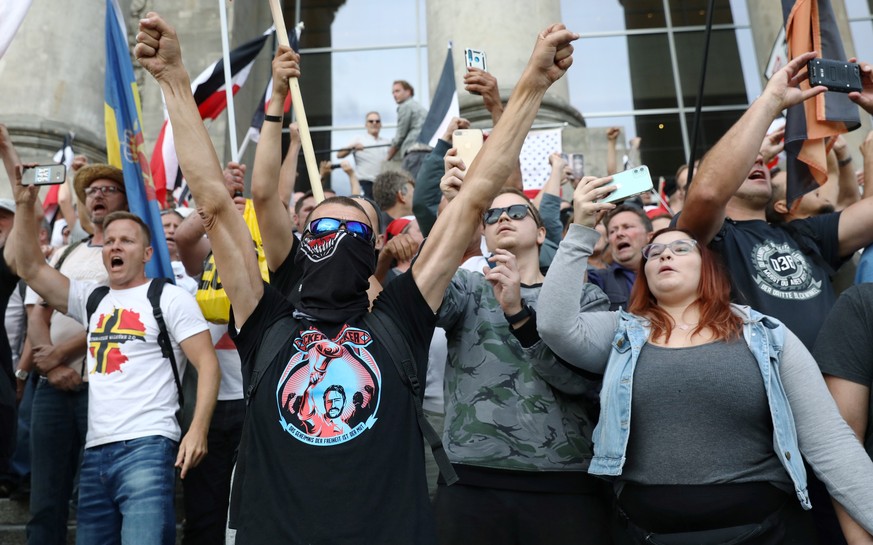 Demonstrators gesture in front of the Reichstag Building during a rally against the government&#039;s restrictions following the coronavirus disease (COVID-19) outbreak, in Berlin, Germany, August 29, ...