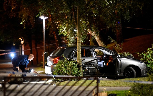 FILE PHOTO: Police technicians examine the car which people who were injured were traveling in, after a shooting in southern Malmo, Sweden September 25, 2016. TT News Agency/Emil Langvad via Reuters/F ...