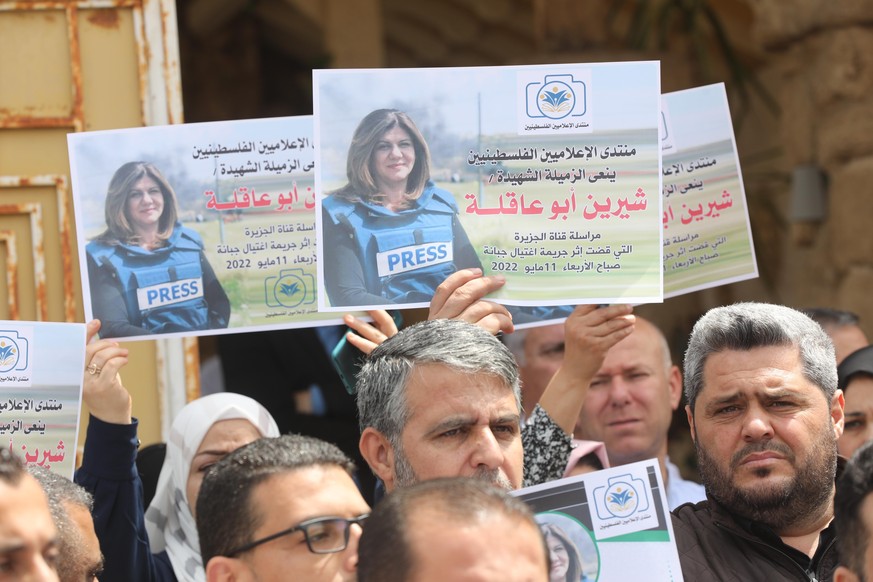 May 11, 2022, Gaza city, Gaza Strip, Palestinian Territory: Palestinian journalists hold posters during a protest against the killing of Al Jazeera journalist Shireen Abu Aqleh, who was, shot dead by  ...