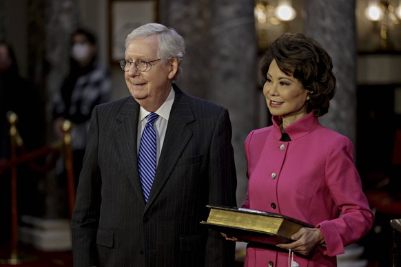 Senate Majority Leader Mitch McConnell, a Republican from Kentucky, left, waits to be ceremoniously sworn-in with wife Elaine Chao, U.S. secretary of transportation, at the U.S. Capitol in Washingtona ...