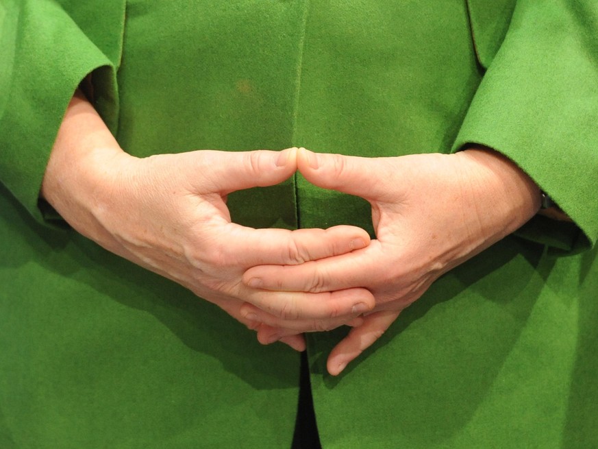 The hands of German Chancellor Angela Merkel are seen as she visits the Software AG booth at the information technology fair CEBIT in Hanover, Germany, 06 March 2012. Some 600,000 visitors are expecte ...