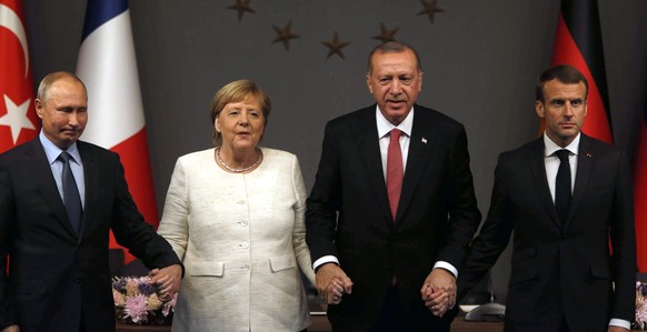From left, Russian President Vladimir Putin, German Chancellor Angela Merkel, Turkey's President Recep Tayyip Erdogan and French President Emmanuel Macron pose at the end of a news conference followin ...