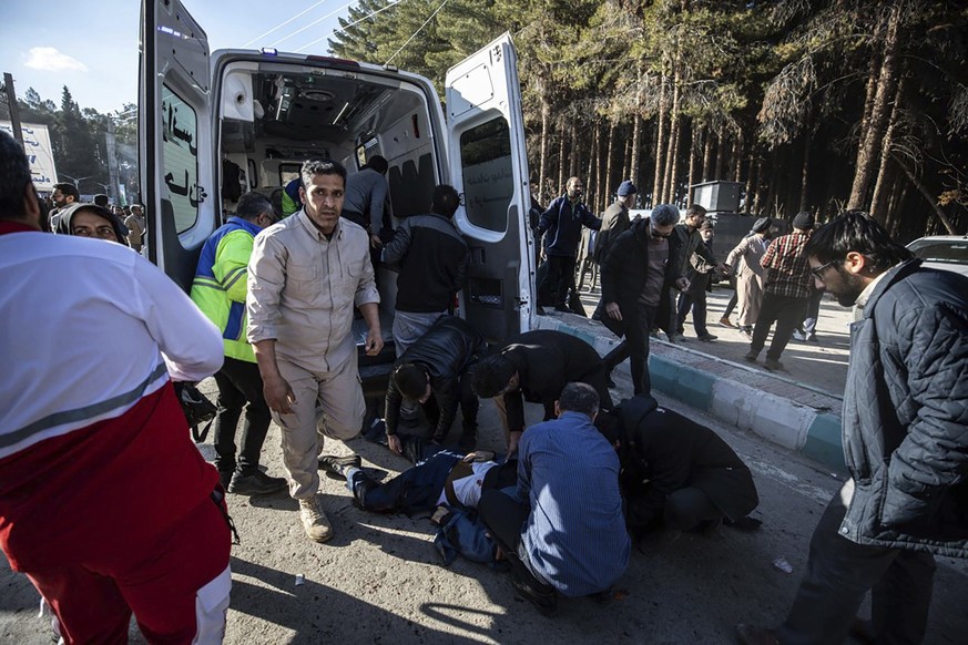 ADDS SOURCE - Injured people get aid after an explosion in Kerman, Iran, Wednesday, Jan. 3, 2024. Iran says the deadly twin bomb blasts occurred at an event honoring a prominent Iranian general slain  ...