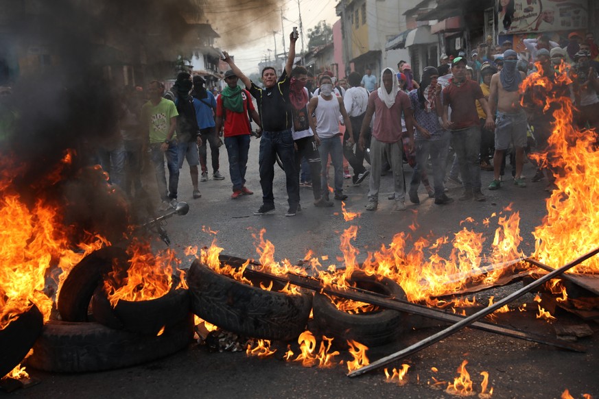 Demonstrators man a barricade during clashes with the Bolivarian National Guard in Urena, Venezuela, near the border with Colombia, Saturday, Feb. 23, 2019. Venezuela's National Guard fired tear gas o ...