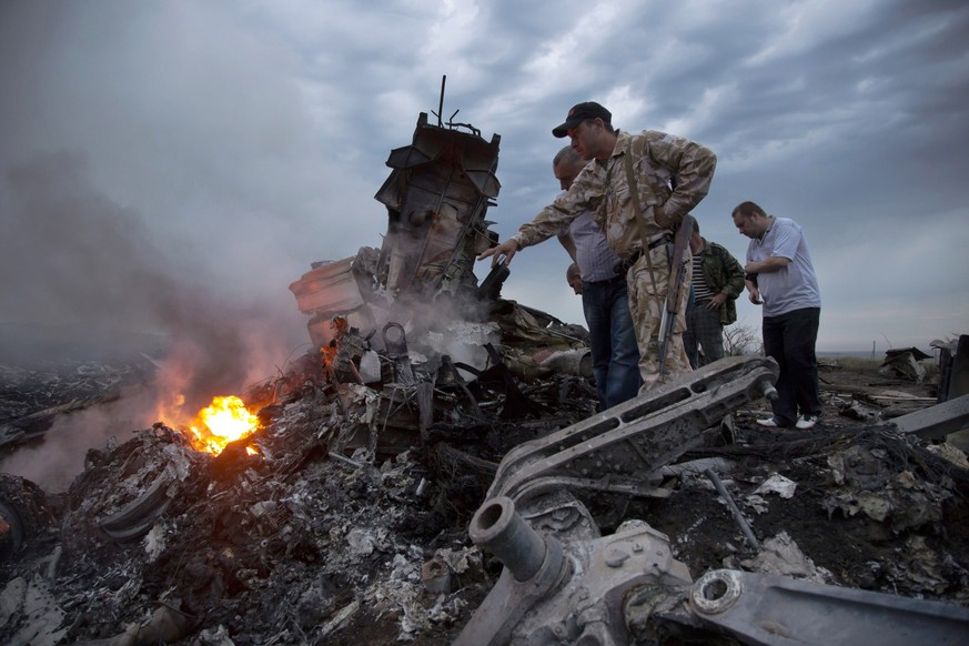 FILE - People inspect the crash site of a passenger plane near the village of Hrabove, Russian-controlled Donetsk region of Ukraine on Thursday, July 17, 2014. Europe&#039;s top human rights court rul ...