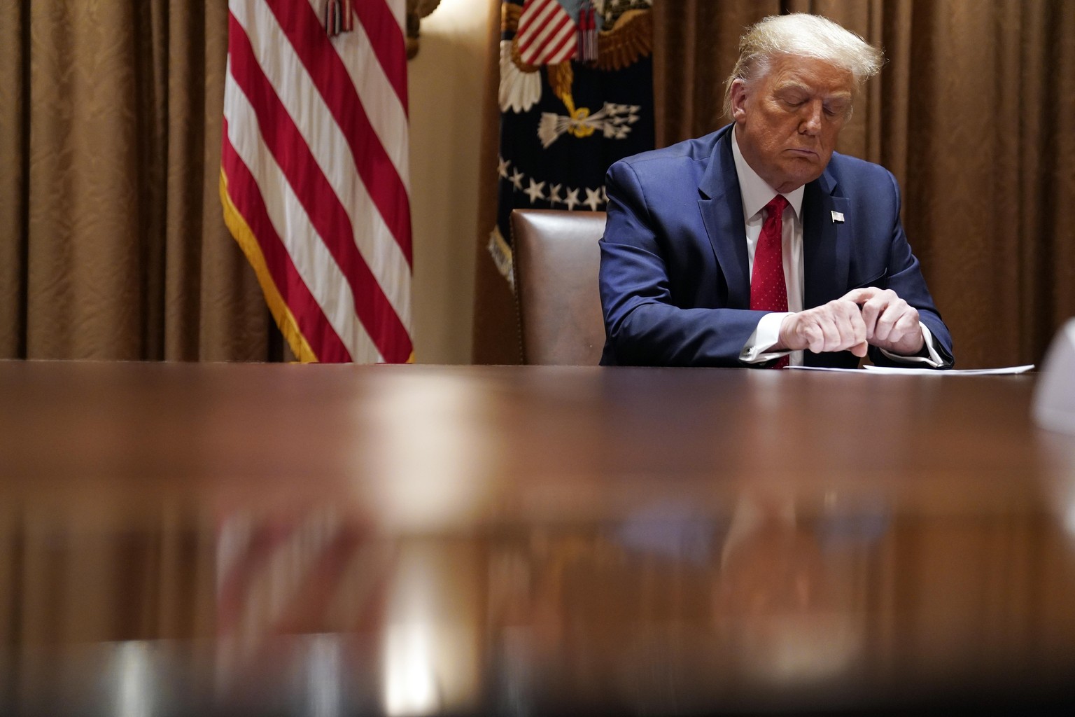 FILE - In this July 9, 2020, file photo President Donald Trump listens during a meeting with Hispanic leaders in the Cabinet Room, Thursday, July 9, 2020, in Washington. Republicans are trying to conv ...