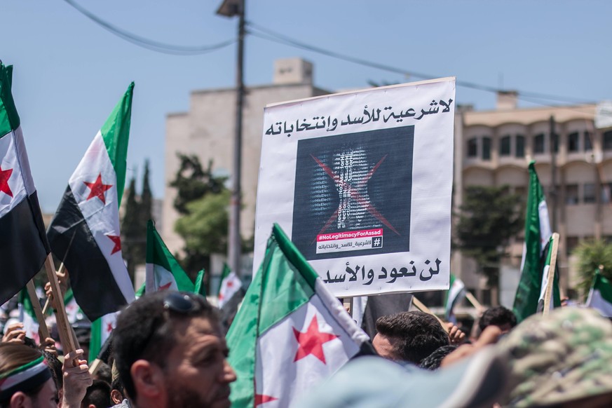Syrians reject the Syrian elections. Syria-Idlib May 26, 2021: Hundreds of civilians from Idlib governorate and its countryside demonstrate in a public square inside the city of Idlib, in opposition t ...