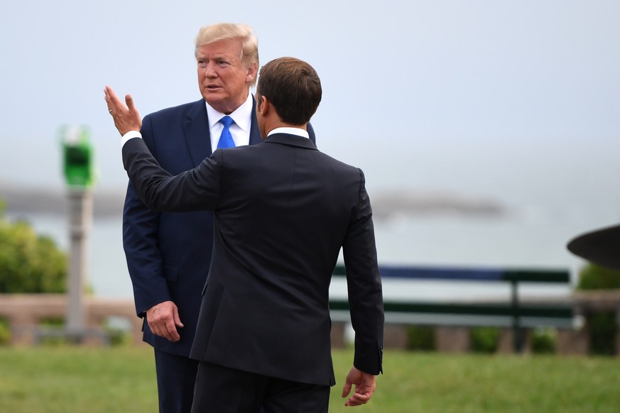 BIARRITZ, FRANCE - AUGUST 24: French President Emmanuel Macron (R) welcomes US President Donald Trump (L) ahead of a working dinner at the Biarritz lighthouse on August 24, 2019 in Biarritz, France. T ...